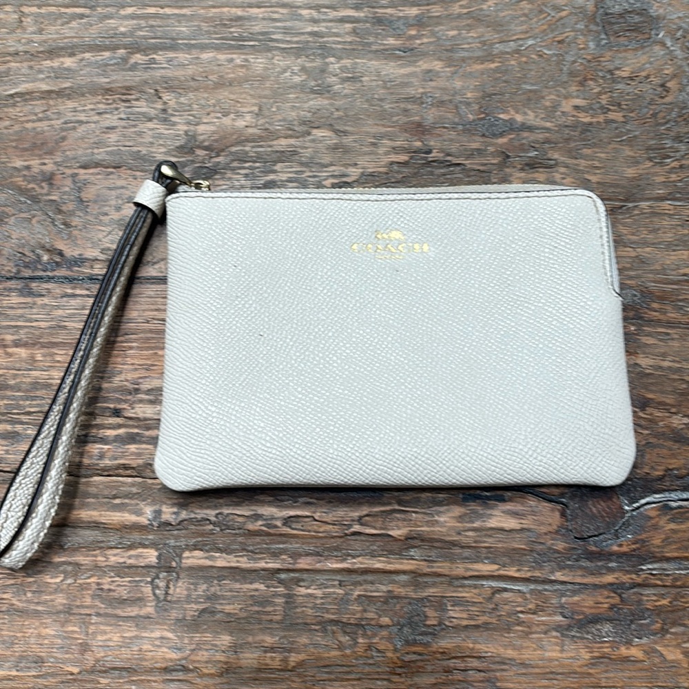 White/cream Coach wristlet